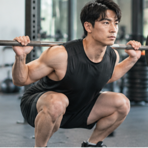 "Man performing a barbell squat in the gym as part of a strength training routine for weight loss"
